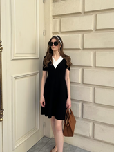 a lady in a black and white contrast v-neck slim knitted midi dress